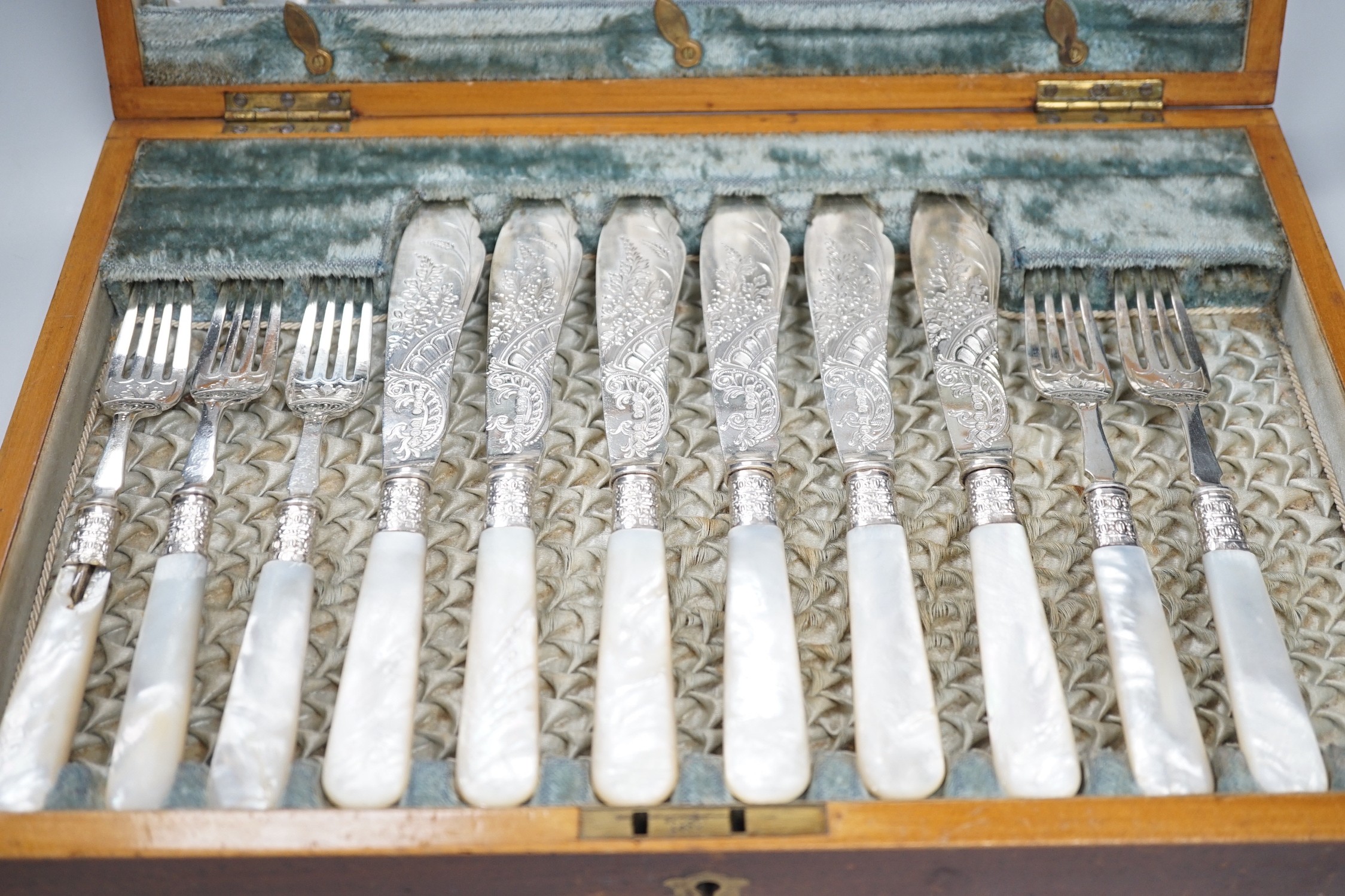 A cased set of twelve pairs of Victorian mother of pearl handed silver fish eaters (fork missing) R.F. Mosley & Co, Sheffield, 1894/1895 and a later cased set of twelve pairs of silver handled dessert eaters.